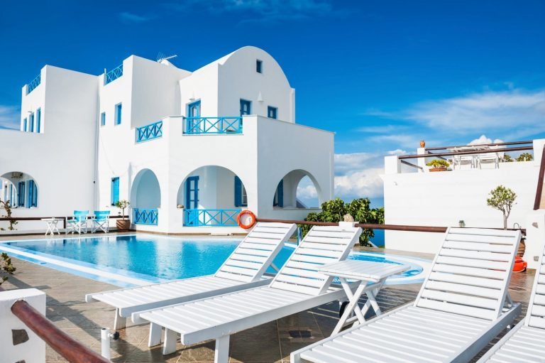 Beautiful luxury hotel with swimming pool. White architecture on Santorini island, Greece.
